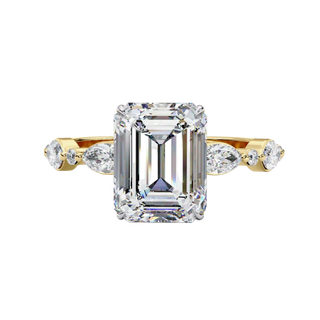 Front view of a yellow gold emerald cut diamond engagement ring with alternating marquise and round accent diamonds.
