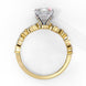 Side profile view of a yellow gold emerald cut diamond engagement ring highlighting the open under-gallery construction.