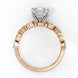 Side profile view of a rose gold emerald cut diamond engagement ring highlighting the open under-gallery construction.