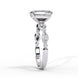 Side profile view of a white gold emerald cut diamond engagement ring showing the elegant cathedral gallery profile.
