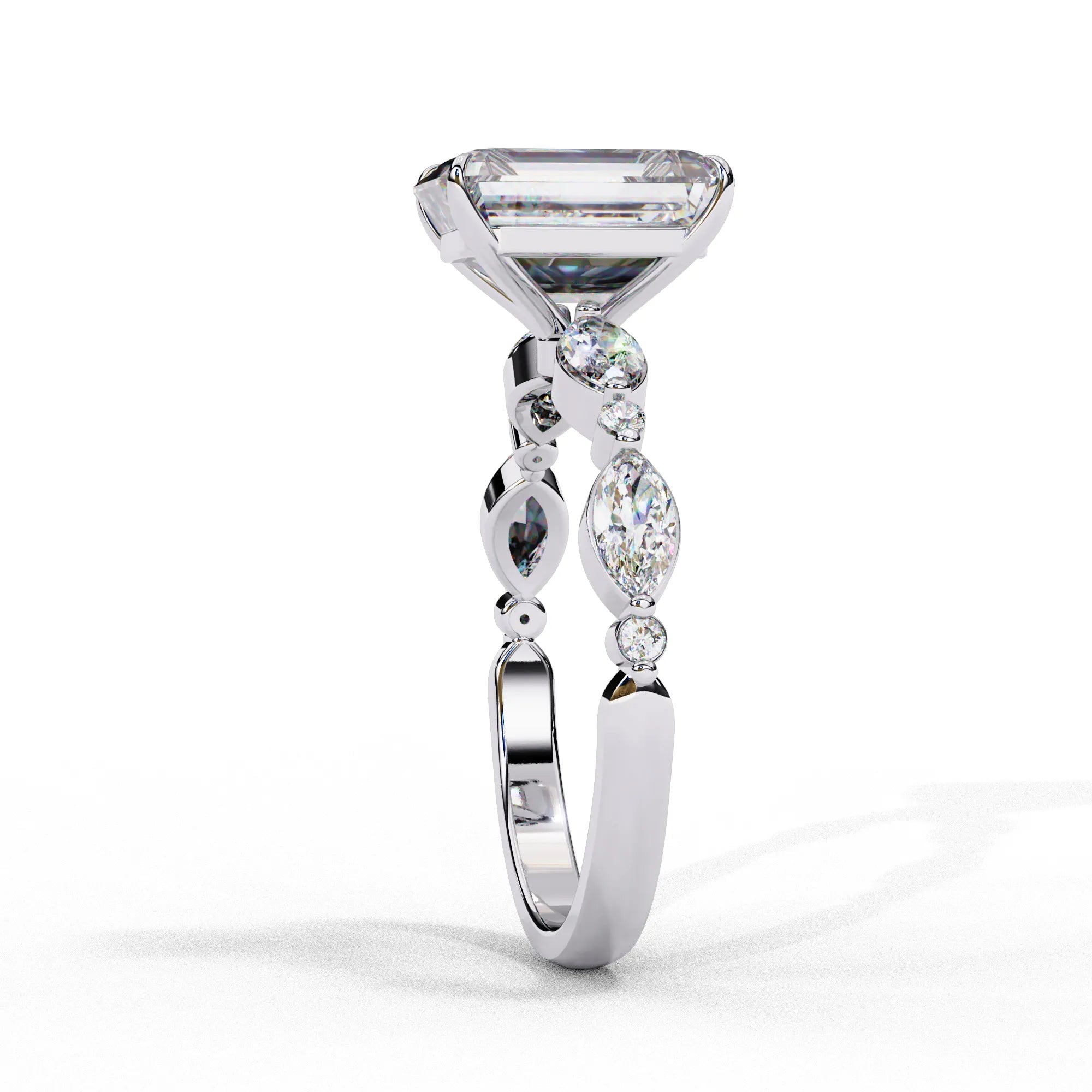 Side profile view of a white gold emerald cut diamond engagement ring showing the elegant cathedral gallery profile.