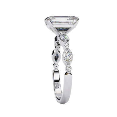 Side profile view of a white gold emerald cut diamond engagement ring showing the elegant cathedral gallery profile.