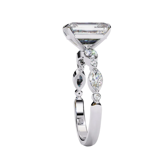 Side profile view of a white gold emerald cut diamond engagement ring showing the elegant cathedral gallery profile.