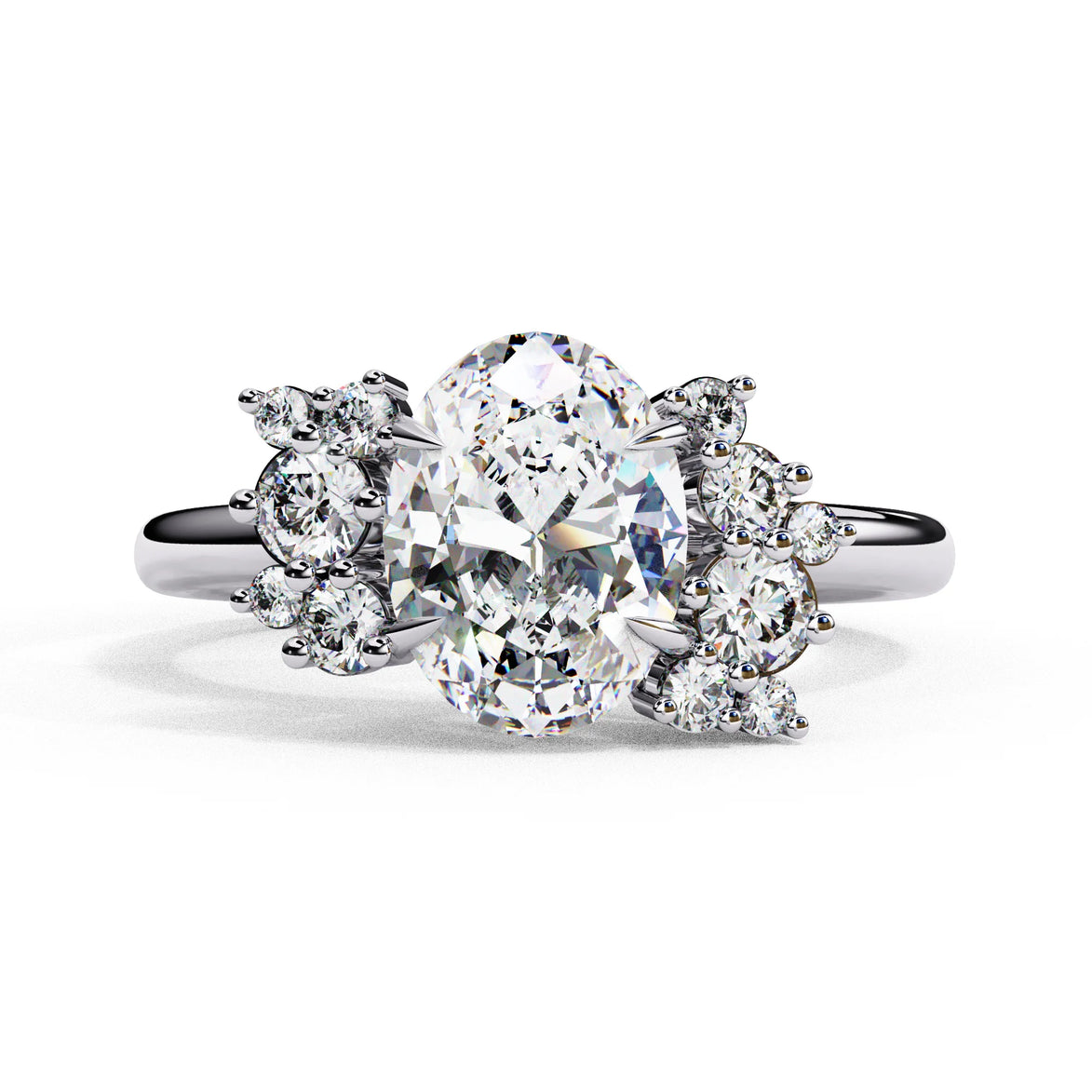 Front view of a white gold oval cut diamond engagement ring featuring symmetrical floral cluster side stones.