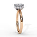 Side profile view of a rose gold oval cut diamond engagement ring highlighting the open under-gallery construction.