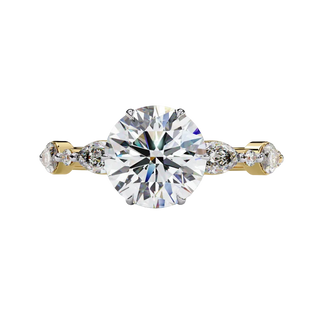 Front view of a white gold round brilliant cut diamond engagement ring with symmetrical marquise and bezel-set side stones.