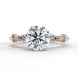 Front view of a rose gold round brilliant cut diamond engagement ring with symmetrical marquise and bezel-set side stones.