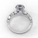 Side profile view of a white gold round brilliant cut diamond engagement ring highlighting the open under-gallery construction.