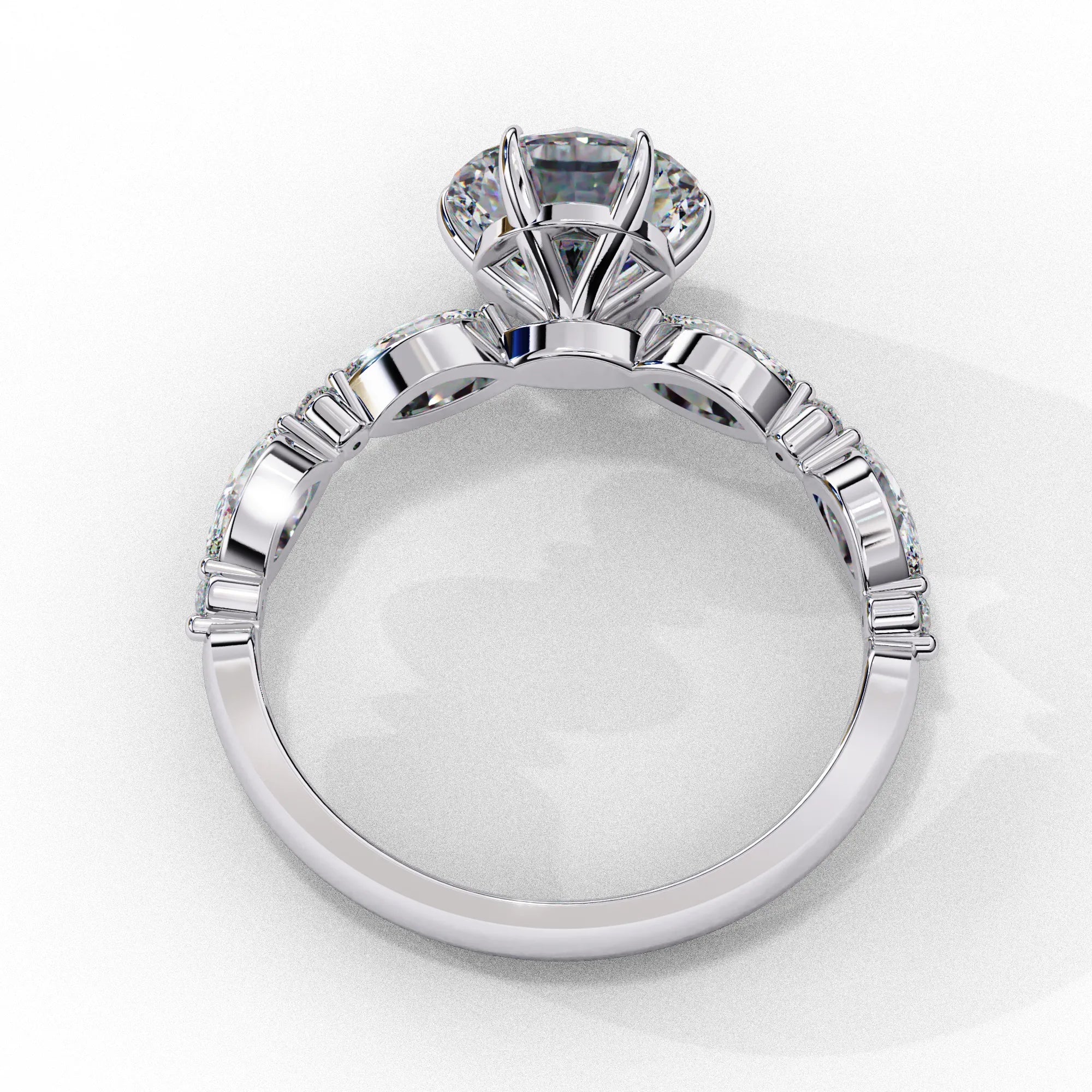 Side profile view of a white gold round brilliant cut diamond engagement ring highlighting the open under-gallery construction.