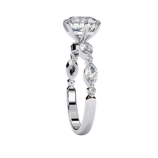 Side profile view of a white gold round brilliant cut diamond engagement ring showcasing an elegant cathedral gallery profile.