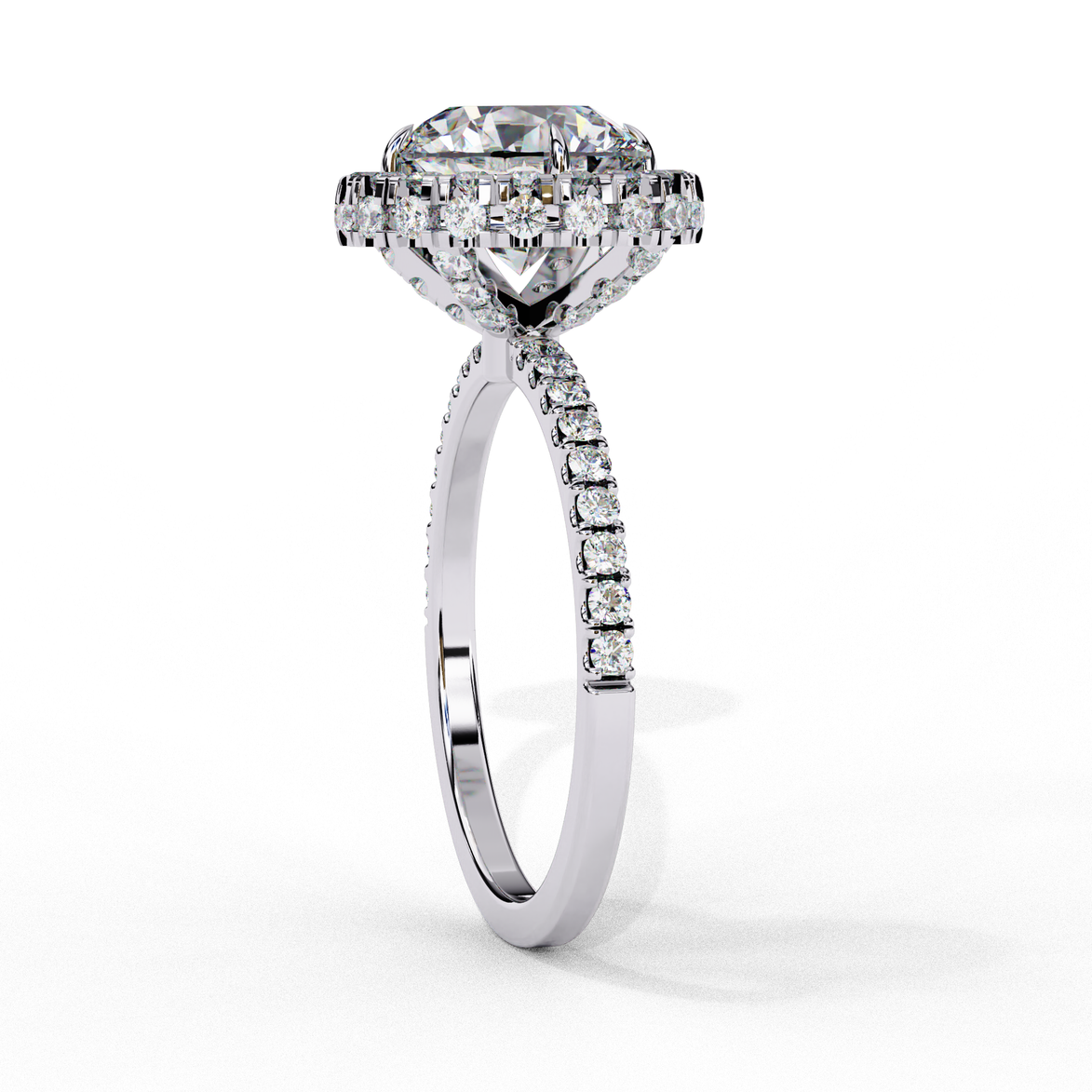 Side profile view of a white gold round brilliant diamond double halo engagement ring with a cathedral setting.