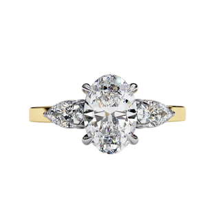 yellow gold oval cut diamond ring with pear side stones, front view.