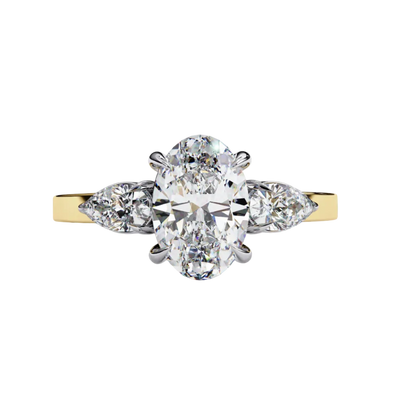 yellow gold oval cut diamond ring with pear side stones, front view.