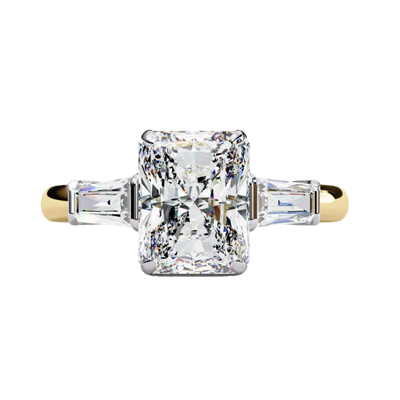 Yellow gold radiant cut diamond ring with tapered baguette side stones, front view.