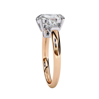 Side profile of rose gold emerald diamond ring showing cathedral setting.