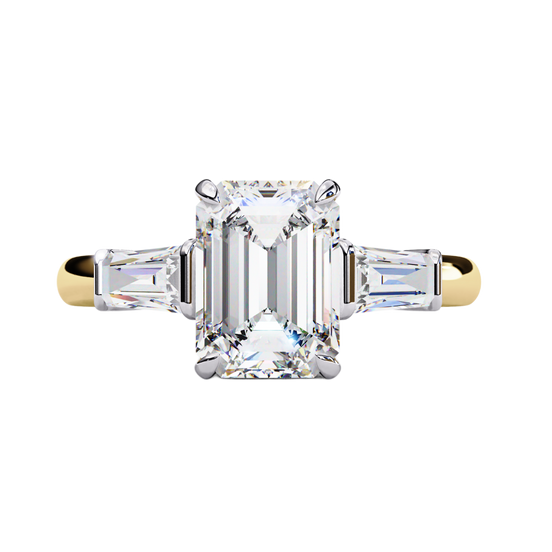 Yellow gold emerald cut diamond ring with tapered baguette side stones, front view.