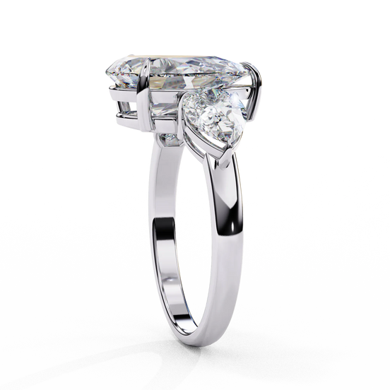 Side profile view of a white gold pear-cut diamond three-stone ring standing vertically.