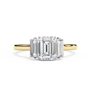Front-facing view of a yellow gold emerald cut three stone diamond engagement ring.