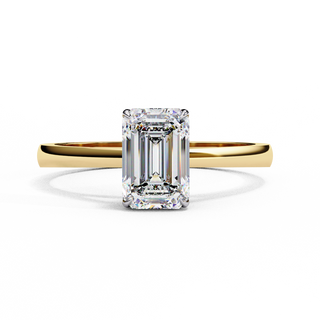 Front-facing view of a yellow gold emerald cut cathedral solitaire ring.