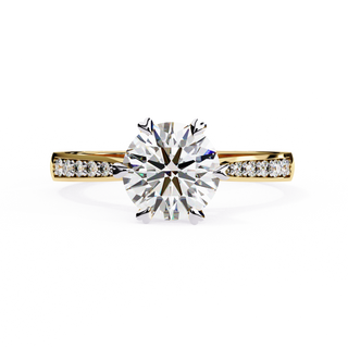 Front-facing view of a yellow gold round diamond pavé engagement ring.