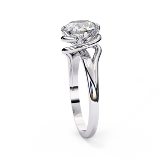 Side profile view of a white gold round diamond bypass solitaire ring.