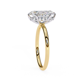 Side profile view of a yellow gold marquise diamond cathedral solitaire ring.