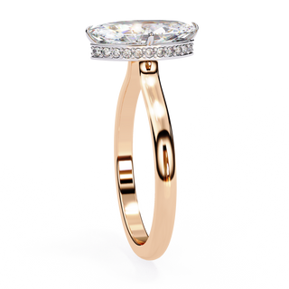 Side profile view of a rose gold marquise hidden halo diamond ring.