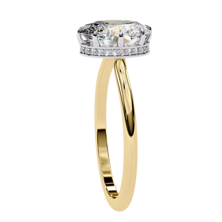 Side profile view of a yellow gold oval hidden halo diamond ring.