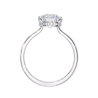 Side profile view of a white gold round hidden halo diamond ring.