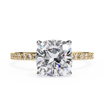 yellow gold ring with a large diamond and smaller diamonds on the band against a white background