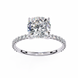 Diamond ring with a large central gemstone and smaller stones on the band against a white background