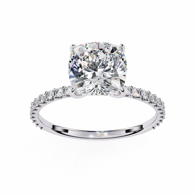 Diamond ring with a large central gemstone and smaller stones on the band against a white background
