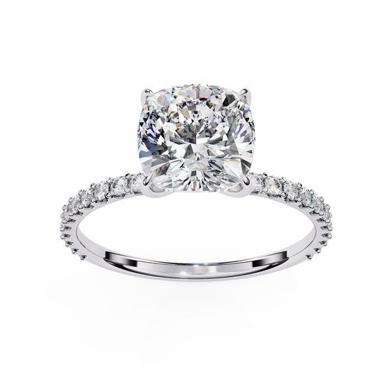 Diamond ring with a large central gemstone and smaller stones on the band against a white background