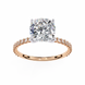 Rose gold ring with a large diamond and smaller diamonds on the band against a white background