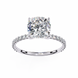 Diamond ring with a large central gemstone and smaller stones on the band against a white background