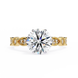 Gold ring with a large diamond and smaller diamonds on the band against a white background