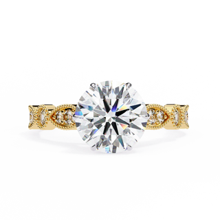Gold ring with a large diamond and smaller diamonds on the band against a white background
