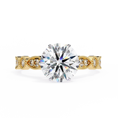 Gold ring with a large diamond and smaller diamonds on the band against a white background