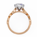 Rose gold ring with a diamond on a white background