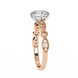 Rose gold ring with a large diamond and smaller diamonds on a white background