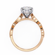 Rose gold ring with a diamond on a white background
