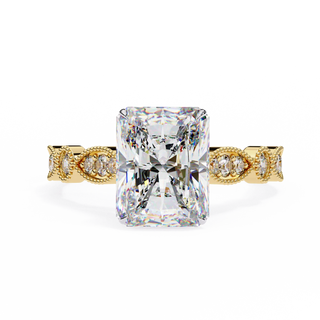 Gold ring with a large diamond and smaller diamonds on the band against a white background