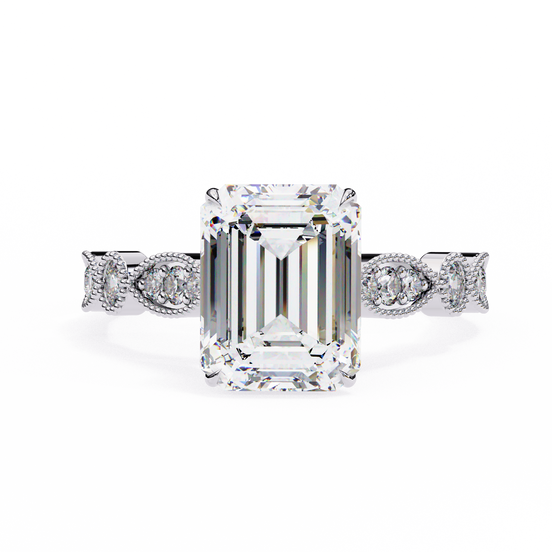 Diamond ring with emerald-cut center stone and diamond side stones on a white background