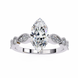 Diamond ring with a pear-shaped center stone on a white background