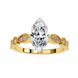 Gold ring with a large pear-shaped diamond and smaller diamonds on a white background