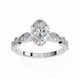 Diamond ring with a central oval-cut diamond and smaller round diamonds on a white background