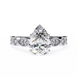 Diamond ring with a pear-shaped center stone on a white background