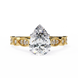 Rose gold ring with a pear-shaped diamond on a white background