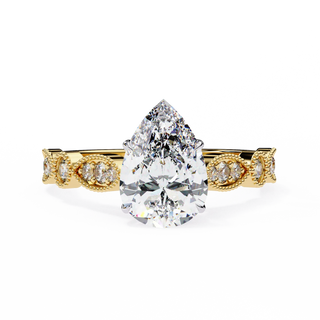 Rose gold ring with a pear-shaped diamond on a white background