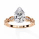 Rose gold ring with a large pear-shaped diamond and smaller diamonds on the band against a white background